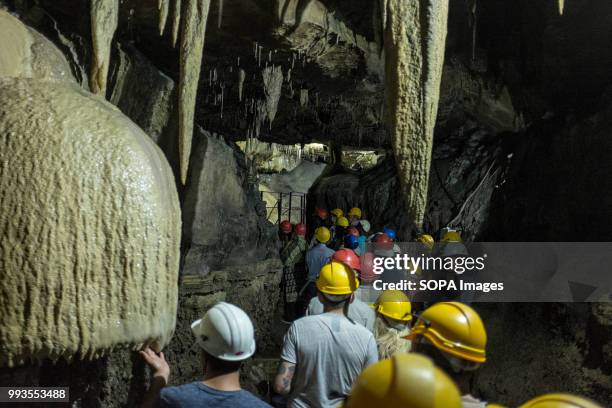 People seen inside the cave. Ingleborough Cave is a beautiful cave close to the village of Clapham in North Yorkshire, England adjacent to where the...