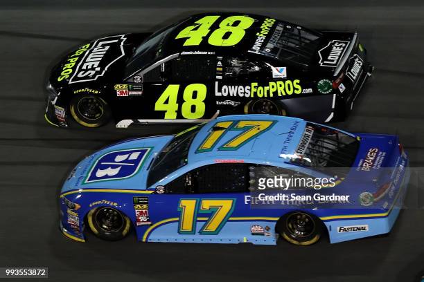 Jimmie Johnson, driver of the Lowe's for Pros Chevrolet, races Ricky Stenhouse Jr., driver of the Fifth Third Bank Ford, during the Monster Energy...