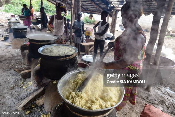 People prepare "attieke", a side dish made from cassava , in Affery, on June 25, 2018. - Researchers from half a dozen states in West Africa have...