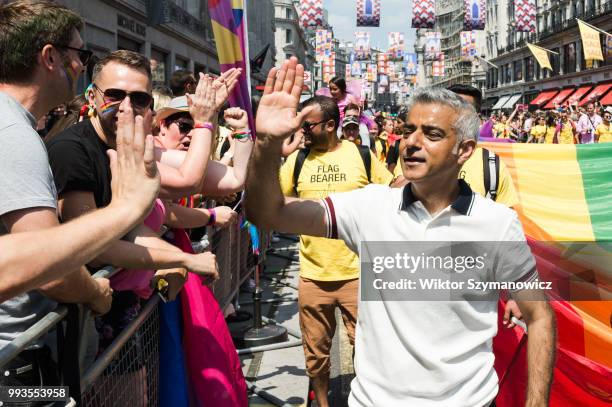 Mayor of London Sadiq Khan high-fives revellers lining Regents Street during Pride in London parade. The annual festival attracts hundreds of...