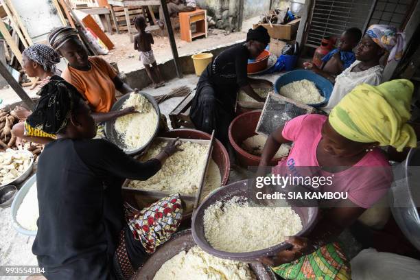 Women prepare semolina of cassava for the preparation of the attieke side dish in Abidjan, on May 22, 2018. - Researchers from half a dozen states in...