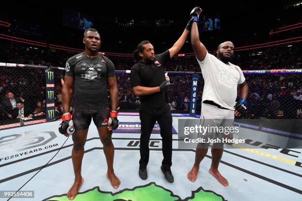 Derrick Lewis raises his hand over Francis Ngannou of Cameroon after their heavyweight fight during the UFC 226 event inside T-Mobile Arena on July...