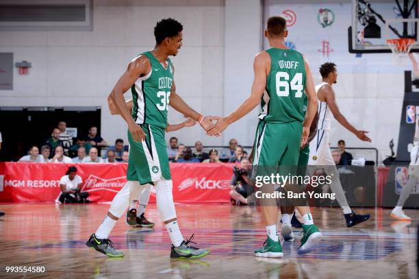 Jarell Eddie and Jarrod Uthoff of the Boston Celtics high five during the game against the Denver Nuggets during the 2018 Las Vegas Summer League on...