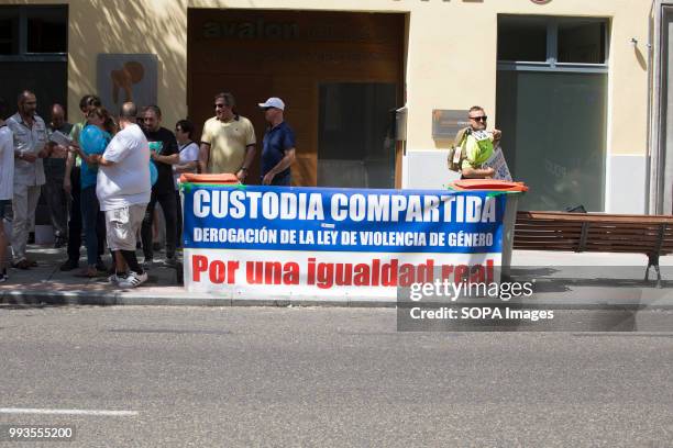 Protesters seen holding a banner that says, Joint custody, repeal of the law of gender violence, for a real equal. Parents demonstrate in front of...