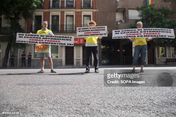 Protesters seen holding posters that say, I'm not a visitor, not an ATM, I'm a father, Joint custody now. Parents demonstrate in front of the PSOE...