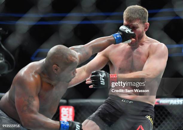Daniel Cormier punches Stipe Miocic during their heavyweight championship fight at T-Mobile Arena on July 7, 2018 in Las Vegas, Nevada. Cormier won...