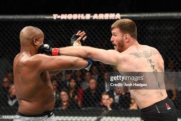 Stipe Miocic punches Daniel Cormier in their UFC heavyweight championship fight during the UFC 226 event inside T-Mobile Arena on July 7, 2018 in Las...