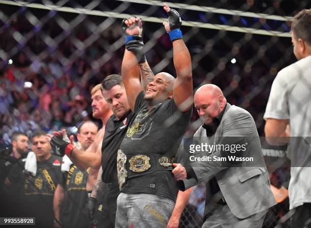 President Dana White places the championship belt around the waist of Daniel Cormier after he defeated Stipe Miocic in their heavyweight championship...