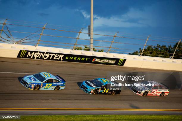 Ricky Stenhouse Jr., driver of the Fifth Third Bank Ford, leads Michael McDowell, driver of the K-LOVE Radio Ford, and Austin Dillon, driver of the...