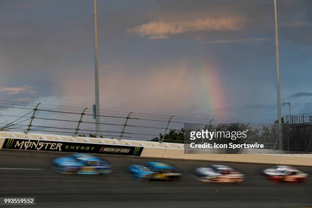 Rainbow shines over turn 3 as cars race through the turn during the Coke Zero Sugar 400 on July 7, 2018 at Daytona International Speedway in Daytona...