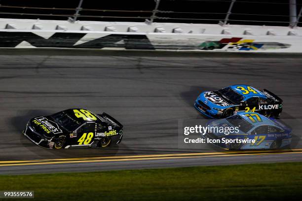 Jimmie Johnson, driver of the Lowes for Pros Chevrolet, leads Ricky Stenhouse Jr., driver of the Fifth Third Bank Ford, and Michael McDowell, driver...