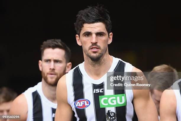 Scott Pendlebury of the Magpies leads his team out onto the field during the round 16 AFL match between the Essendon Bombers and the Collingwood...