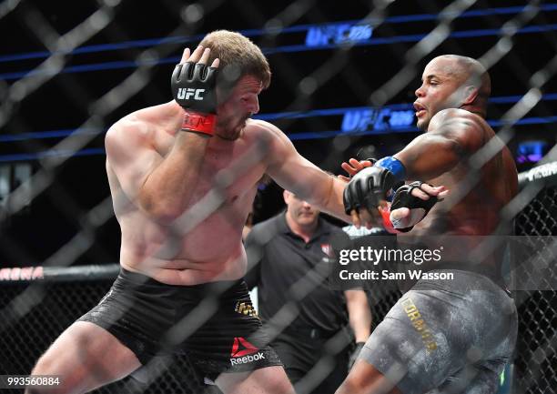 Stipe Miocic throws a punch against Daniel Cormier during their heavyweight championship fight at T-Mobile Arena on July 7, 2018 in Las Vegas,...