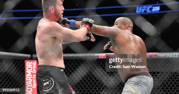 Daniel Cormier throws a punch against Stipe Miocic during their heavyweight championship fight at T-Mobile Arena on July 7, 2018 in Las Vegas,...