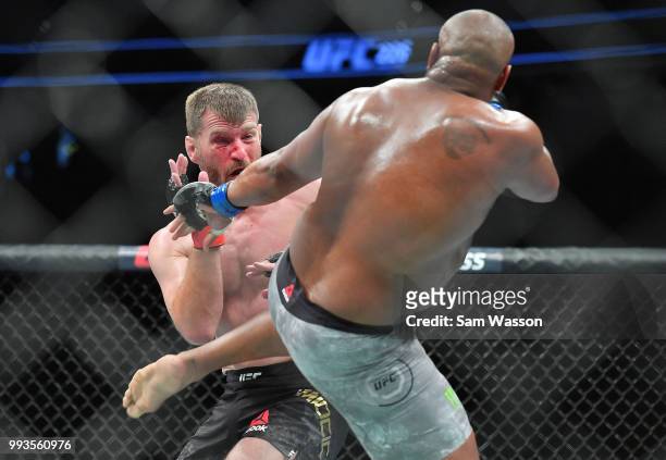Daniel Cormier kicks Stipe Miocic during their heavyweight championship fight at T-Mobile Arena on July 7, 2018 in Las Vegas, Nevada. Cormier won by...