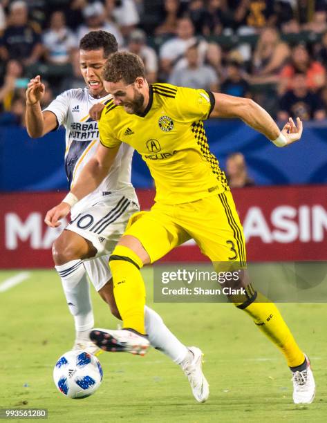 Giovani dos Santos of Los Angeles Galaxy battles Josh Williams of Columbus Crew during the Los Angeles Galaxy's MLS match against Columbus Crew at...