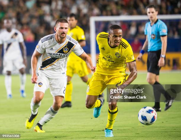 Perry Kitchen of Los Angeles Galaxy battles Ricardo Clark of Columbus Crew during the Los Angeles Galaxy's MLS match against Columbus Crew at the...