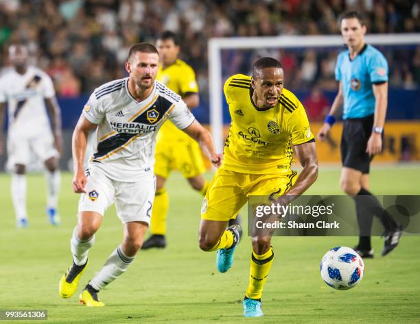 Perry Kitchen of Los Angeles Galaxy battles Ricardo Clark of Columbus Crew during the Los Angeles Galaxy's MLS match against Columbus Crew at the...