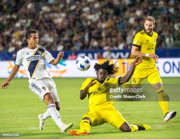 Giovani dos Santos of Los Angeles Galaxy battles Lalas Abubakar of Columbus Crew during the Los Angeles Galaxy's MLS match against Columbus Crew at...