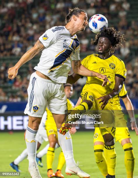 Zlatan Ibrahimovic of Los Angeles Galaxy battles Lalas Abubakar of Columbus Crew during the Los Angeles Galaxy's MLS match against Columbus Crew at...