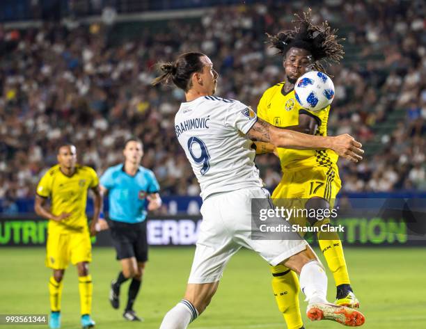Zlatan Ibrahimovic of Los Angeles Galaxy battles Lalas Abubakar of Columbus Crew during the Los Angeles Galaxy's MLS match against Columbus Crew at...
