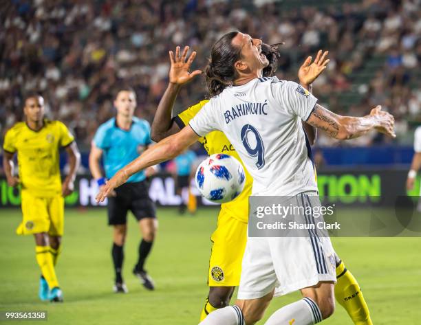 Zlatan Ibrahimovic of Los Angeles Galaxy is fouled by Lalas Abubakar of Columbus Crew during the Los Angeles Galaxy's MLS match against Columbus Crew...