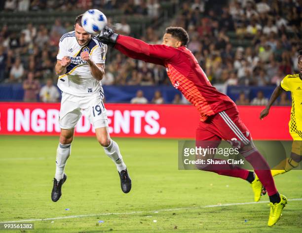 Zack Steffen of Columbus Crew punches the ball clear as Chris Pontius of Los Angeles Galaxy tries to get on the end of a cross during the Los Angeles...