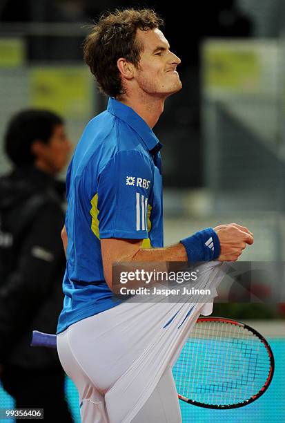 Andy Murray of Great Britain pulls his shorts as he looses a point to David Ferrer of Spain in their quarter final match during the Mutua Madrilena...