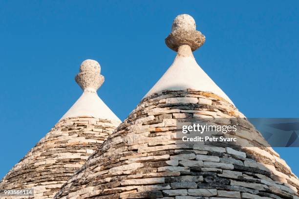 conical roofs and pinnacles of trullo houses, trulli district, alberobello, apulia, italy - conical roof stock pictures, royalty-free photos & images