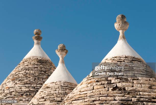 conical roofs and pinnacles of trullo houses, trulli district, alberobello, apulia, italy - conical roof stock pictures, royalty-free photos & images