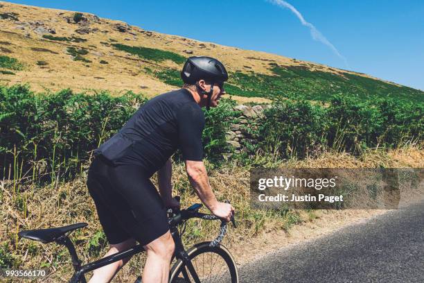 cyclist in the peak district - spandex stock pictures, royalty-free photos & images
