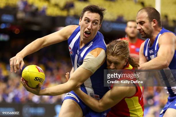 Sam Wright of the Kangaroos handballs during the round 16 AFL match between the North Melbourne Kangaroos and the Gold Coast Suns at Etihad Stadium...