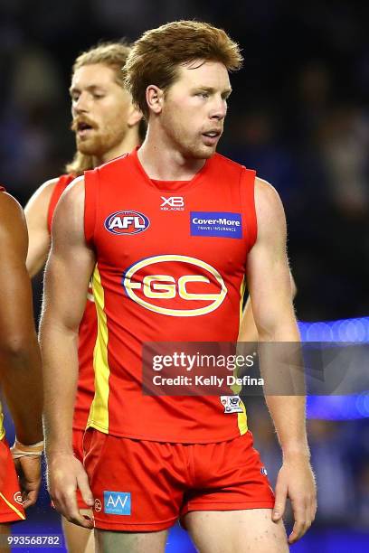 Josh Schoenfeld of the Suns looks dejected after the Suns loss during the round 16 AFL match between the North Melbourne Kangaroos and the Gold Coast...