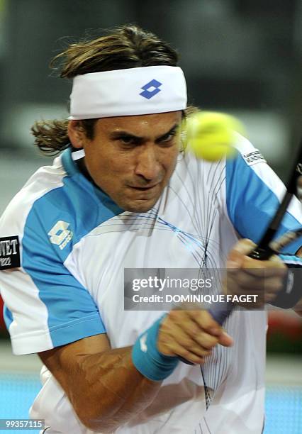 David Ferrer of Spain returns a ball to British Andy Murray during their Madrid Masters tennis match on May 14, 2010 at the Caja Magic sports complex...