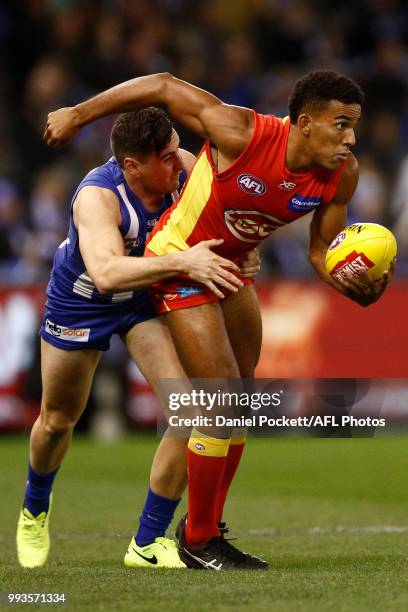 Touk Miller of the Suns handpasses the ball during the round 16 AFL match between the North Melbourne Kangaroos and the Gold Coast Titans at Etihad...