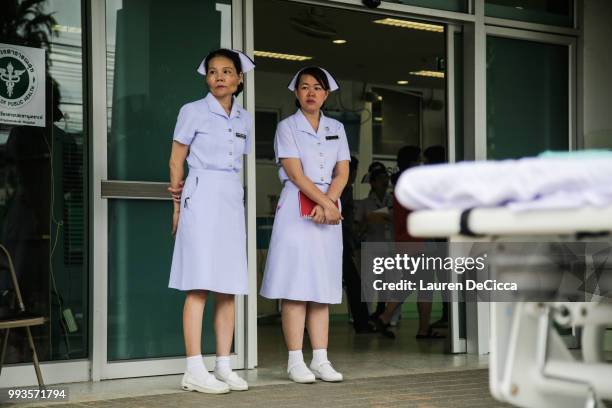 Nurses wait outside the Chaingrai Prachanukroh Hospital, where the boys will be brought upon rescue, on July 8, 2018 in Chiangrai, Thailand. Divers...