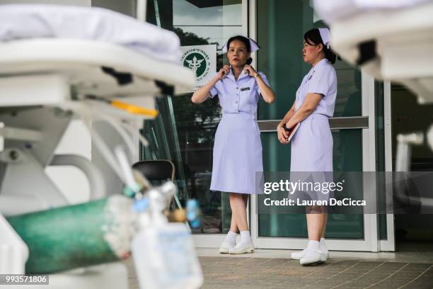 Nurses wait outside the Chaingrai Prachanukroh Hospital, where the boys will be brought upon rescue, on July 8, 2018 in Chiangrai, Thailand. Divers...