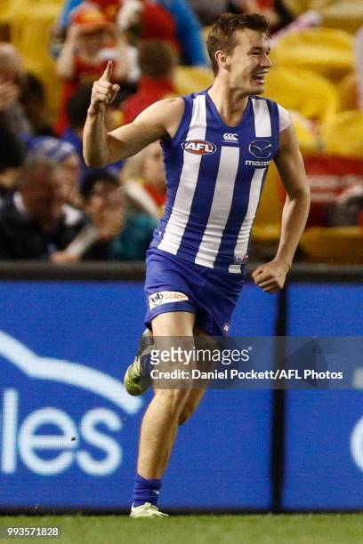 Kayne Turner of the Kangaroos celeberates a goal during the round 16 AFL match between the North Melbourne Kangaroos and the Gold Coast Titans at...