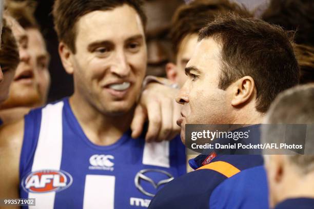 Kangaroos head coach Brad Scott talks to his players during the round 16 AFL match between the North Melbourne Kangaroos and the Gold Coast Titans at...