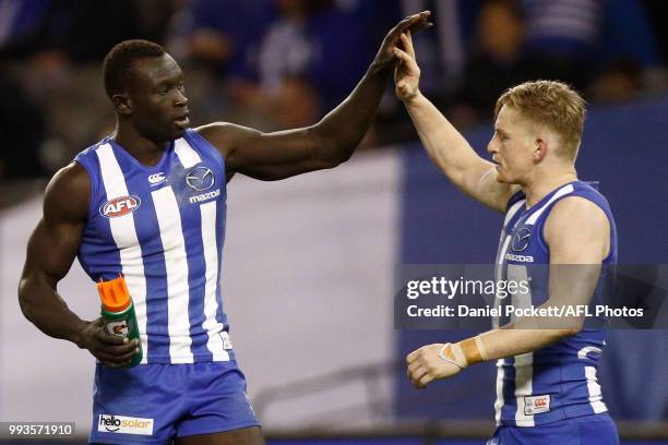 Majak Daw of the Kangaroos celebrates a goal with Jack Ziebell of the Kangaroos during the round 16 AFL match between the North Melbourne Kangaroos...