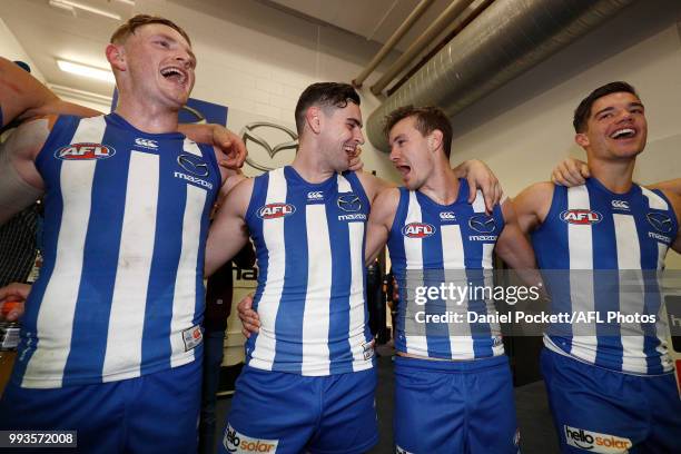 Jack Ziebell, Paul Ahern, Kane Turner and Jy Simpkin of the Kangaroos sing the team song after the round 16 AFL match between the North Melbourne...