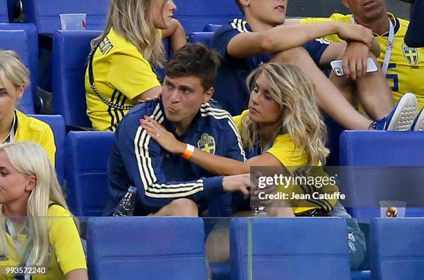 Victor Lindelof of Sweden is consoled by his wife Maja Nilsson following the 2018 FIFA World Cup Russia Quarter Final match between Sweden and...