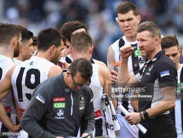 Magpies head coach Nathan Buckley speaks to his players during the round 16 AFL match between the Essendon Bombers and the Collingwood Magpies at...