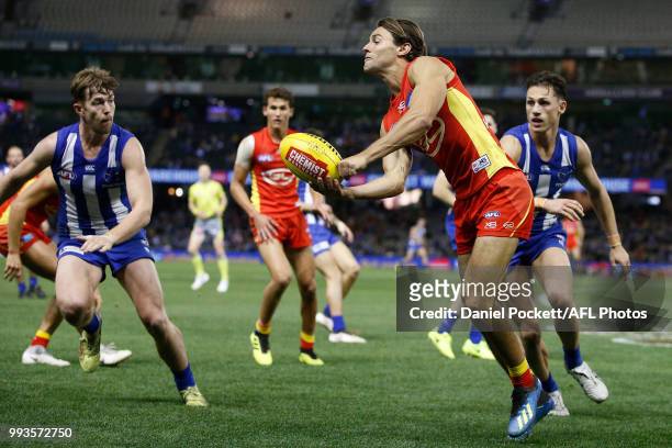 Lachie Weller of the Suns handpasses the ball during the round 16 AFL match between the North Melbourne Kangaroos and the Gold Coast Titans at Etihad...