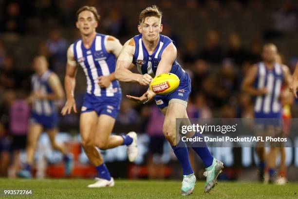 Jack Ziebell of the Kangaroos handpasses the ball during the round 16 AFL match between the North Melbourne Kangaroos and the Gold Coast Titans at...