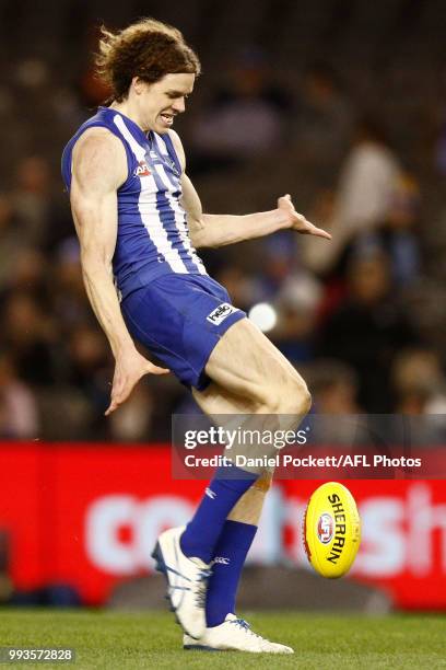 Ben Brown of the Kangaroos kicks at goal during the round 16 AFL match between the North Melbourne Kangaroos and the Gold Coast Titans at Etihad...
