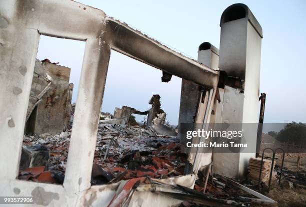 The charred remains of a destroyed home stand in the aftermath of the Holiday Fire on July 7, 2018 in Goleta, California. The fire destroyed a number...