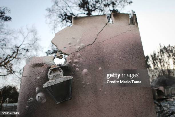 The charred remains of a destroyed home stand in the aftermath of the Holiday Fire on July 7, 2018 in Goleta, California. The fire destroyed a number...