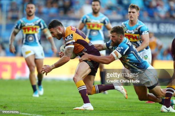 Darius Boyd of the Broncos makes a break to score a try during the round 17 NRL match between the Gold Coast Titans and the Brisbane Broncos at Cbus...