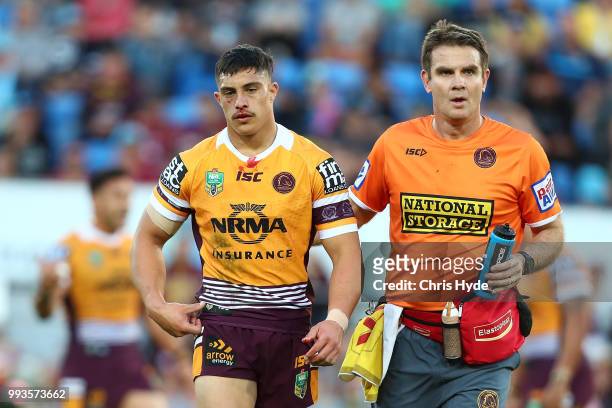 Kotoni Staggs of the Broncos leaves the field injured during the round 17 NRL match between the Gold Coast Titans and the Brisbane Broncos at Cbus...